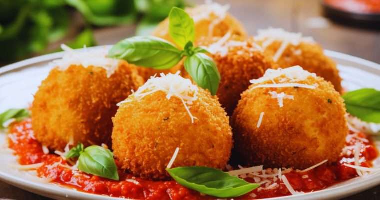 crisp and classic arancini on a homemade tomato sauce