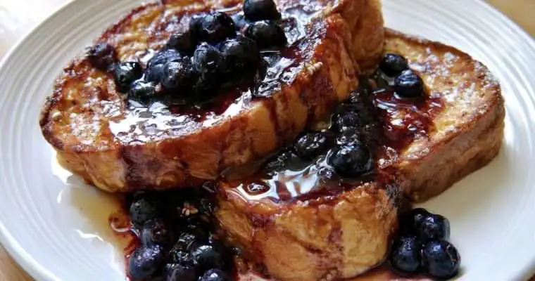 Golden French Toast with juicy blueberries in a maple syrup